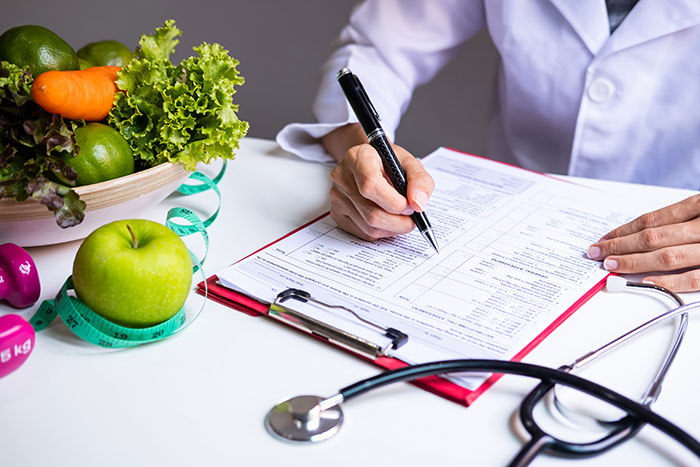 nutrizionista prescrive una dieta al paziente durante le consulenze alimentari