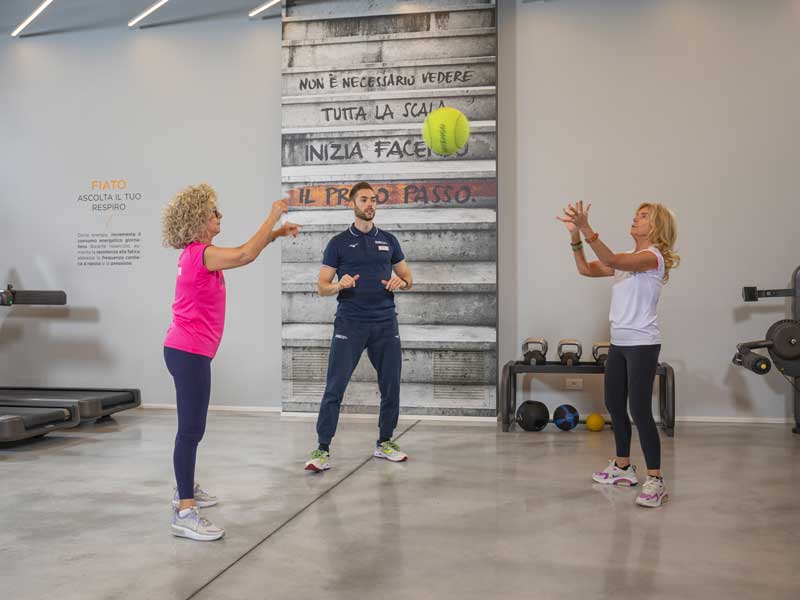 donne sono felici di allenarsi. Stanno facendo un allenamento di fiato e forza seguite da un personal trainer