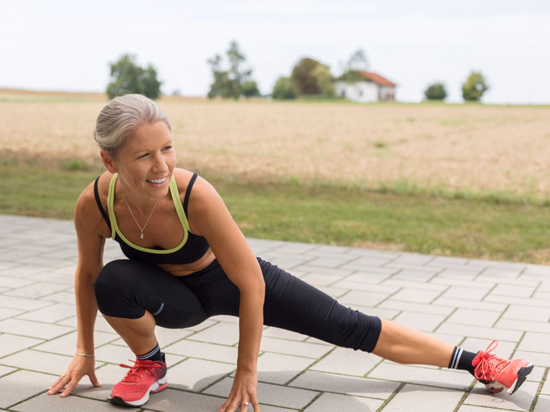 donna si allena all'aperto e fa un allenamento total body